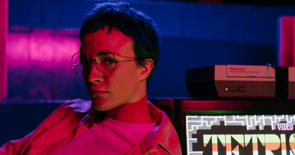 Person with glasses, Nintendo console, and Tetris videogame screen. Retro gaming and exhibitionistic disorder concept.