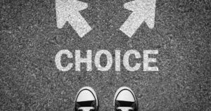 Feet visible at the bottom of the image on a textured surface, with the word CHOICE and two directional arrows overhead, symbolizing making a decision or choosing a path.