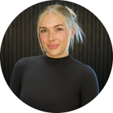 1773344525093-modifiedpng - Lonestar Mental Health Portrait of a woman with blonde hair in a black turtleneck, facing the camera against a dark background.